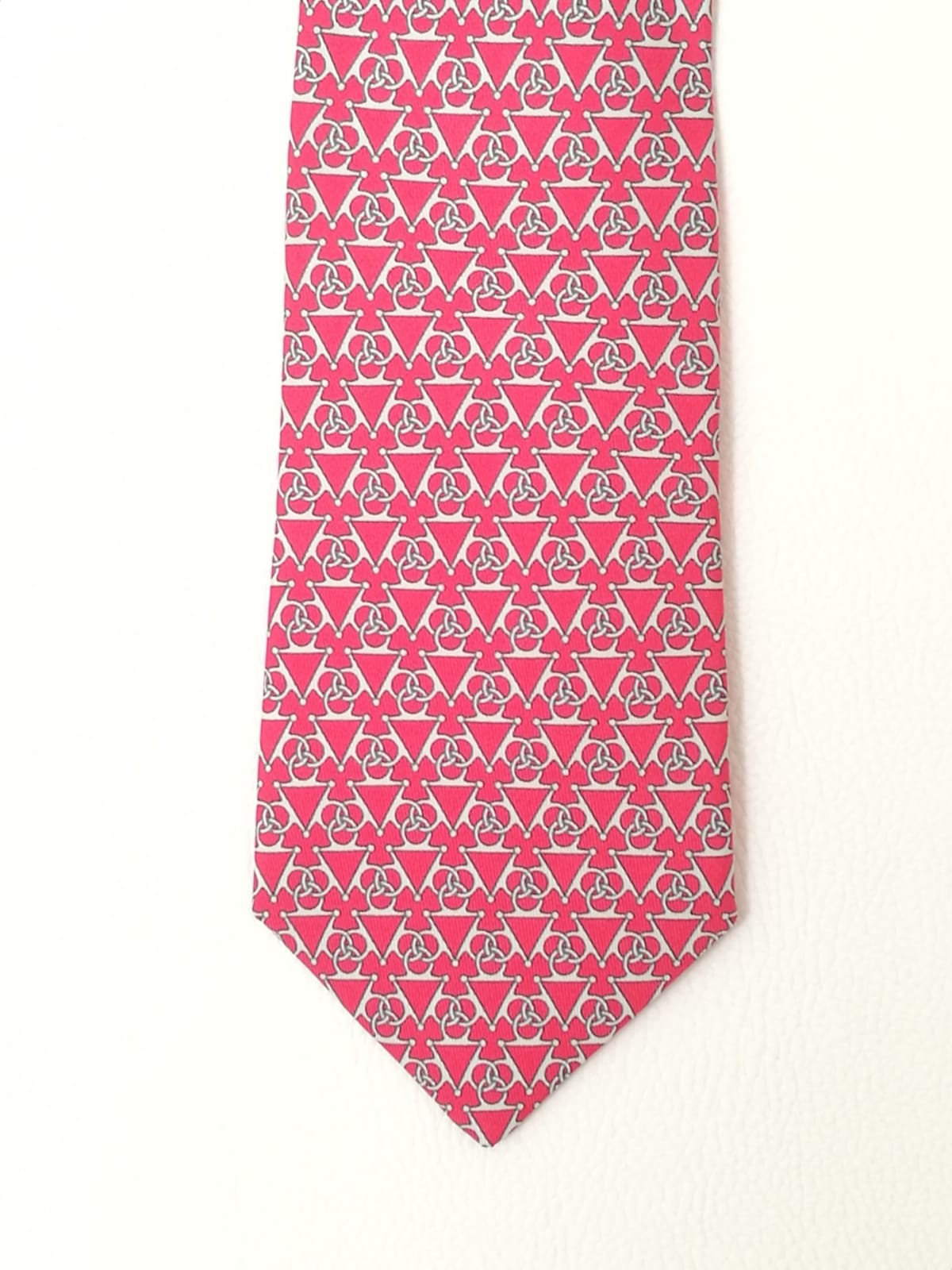 Cravatta Hermès con sfondo rosa con fantasia triangoli con cerchi bianchi